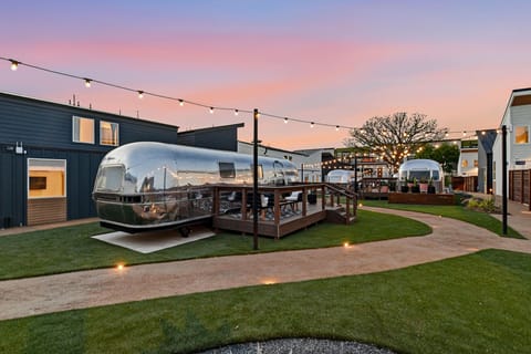The hidden courtyard at the heart of the property, with fire pits, pickleball, and shaded places to gather. Private when you want it, social when you don't.