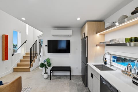A sleek kitchenette with a cooktop and the essentials for quick breakfasts, easy nights in, and longer stays. Plenty of cabinet space for groceries.