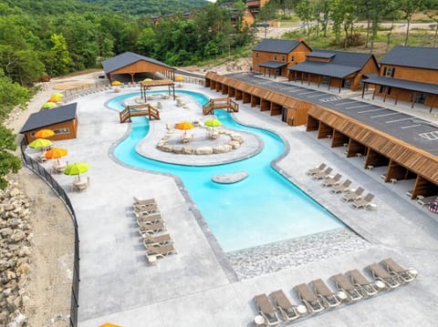 Float the brand-new lazy river and outdoor pool, the sparkling centerpiece of Tall Timbers Camp near Branson.