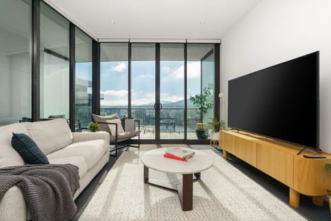 Stretch out and relax in the spacious living area featuring comfortable seating, floor-to-ceiling windows and plenty of natural light.