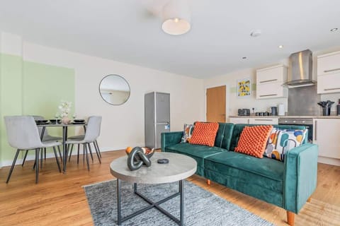 Relax in a light-filled open-plan living space featuring a plush sofa, Smart TV with streaming services, and a sofa bed for added guests. A versatile area designed for comfort, work, or leisure, supported by fast Wi-fi and modern styling.