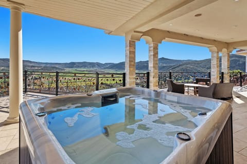 Step onto the loggia and the valley opens past the spa on three sides.
