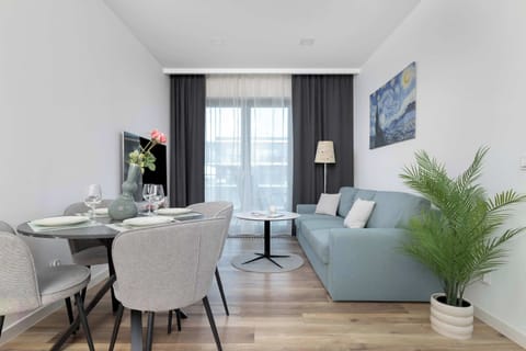Bright living area with comfortable sofa, dining space and modern furnishings.