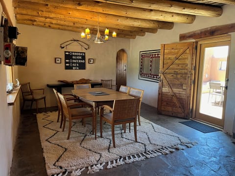 Handcrafted dining table and traditional viga ceilings set the vibe for shared meals and memorable mountain evenings.