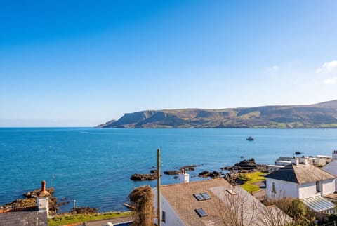 Wake to sweeping blue sea and headland views over the bay.