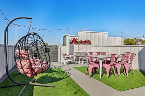 Spacious rooftop deck with dining space and sunny open-air views—perfect for mor