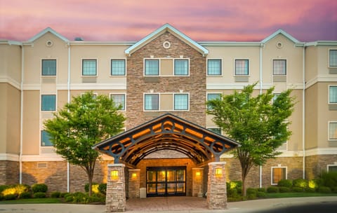 Hotel exterior at dusk — the building is steps from The Shops at Fallen Timbers