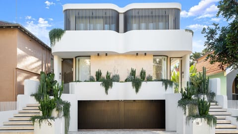 Striking contemporary façade with lush tropical landscaping.
