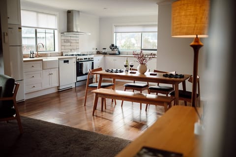 Bright modern kitchen and dining space with warm wood accents