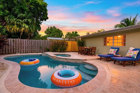 Float, lounge, and dine beside the private pool as the sunset colors the tropical backyard.