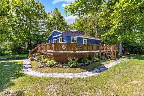 Relax on the spacious wraparound deck surrounded by mature trees.