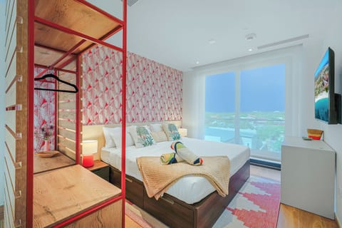 Unwind in your bright coastal retreat with plush bedding, tropical accents, and floor-to-ceiling windows that flood the space with natural light. Your private balcony overlooks the properties neighborhood.