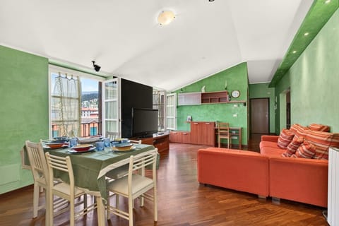 Living area: wide view, large sofa, large dining table, 55-inch TV