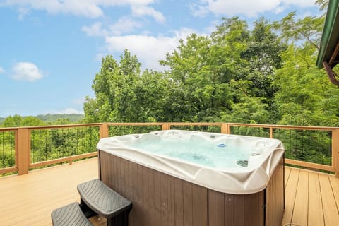 Soak in your private hot tub while gazing at lush rolling hills—the perfect spot to unwind after a day of exploring.