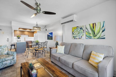 Settle into your bright, open-concept living space, where coastal breezes and cheerful décor invite you to unwind after your day's adventures.