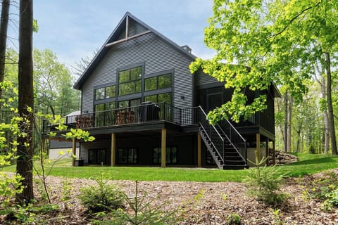 Expansive backyard bordered by tranquil woods, made for time together.
