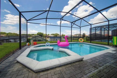 A private screened-in pool and hot tub create the perfect setting for relaxing, cooling off, and enjoying time outdoors