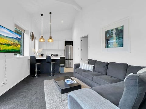 Comfortable open-plan living area with a Smart TV and modern furnishings.
