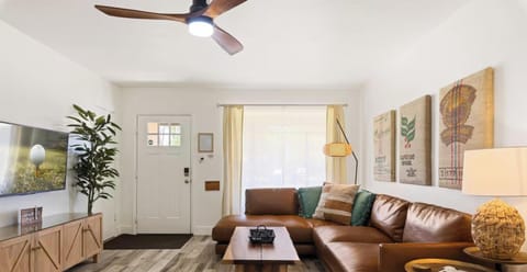 Bright, modern living room with leather sectional and warm stylish decor