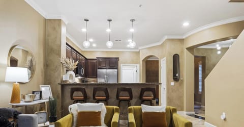 Inviting open living area with breakfast bar seating for four