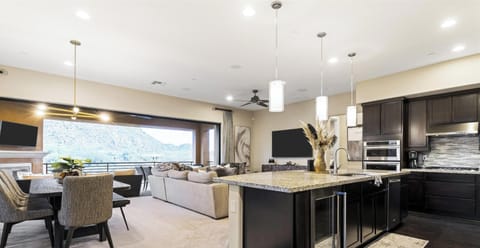 Open-concept kitchen and living area with patio and mountain views