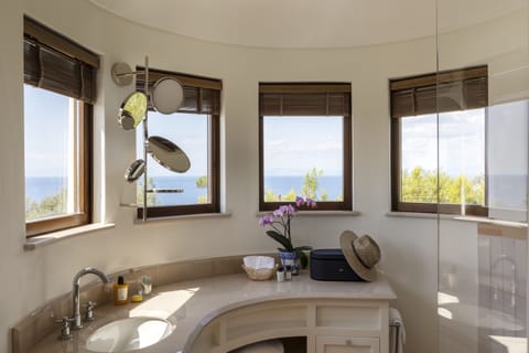 Luxury Suite | Bathroom | Rainfall showerhead, designer toiletries, hair dryer, bathrobes