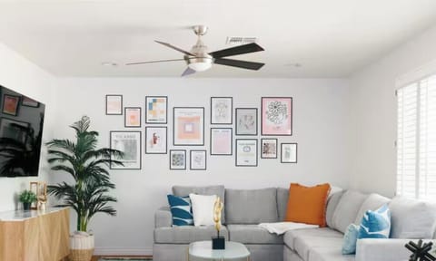 Bright modern lounge with large sectional, gallery wall, and natural light