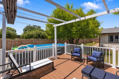 Enjoy sunny days by the pool with stylish seating and vibrant views!