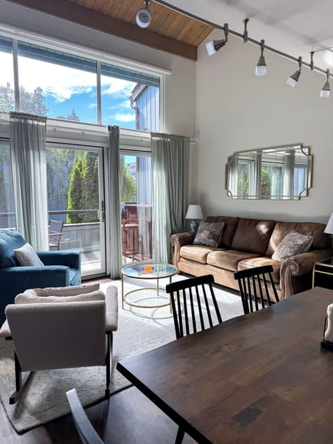 Bright vaulted living room with deck access and abundant natural light