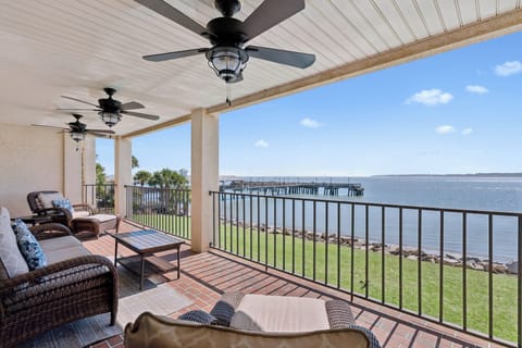 Unwind on your private balcony with stunning water views, where ceiling fans keep you cool as you watch boats drift by.