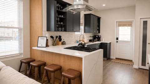 Modern chef’s kitchen with waterfall island and seating for four