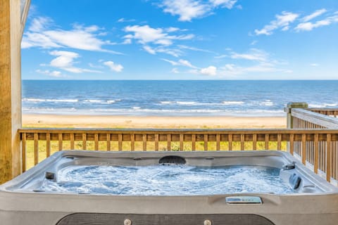 Unwind in the private hot tub while overlooking the sandy beach and sparkling ocean. This inviting outdoor retreat provides a front-row view of the beautiful Gulf Coast.