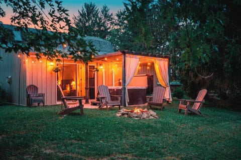 Your private backyard retreat awaits. Soak in the hot tub beneath the covered pergola, gather around the fire pit, and enjoy peaceful evenings surrounded by nature.