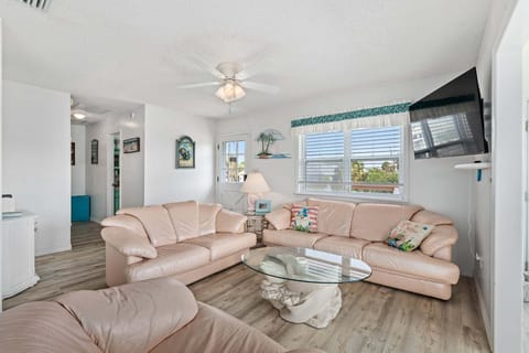 The living room offers comfortable seating arranged for easy conversation and relaxation, creating a welcoming space for guests.