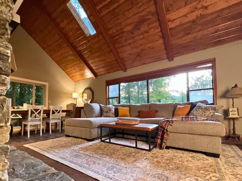 Vaulted wood ceilings with a large sectional in the living room.