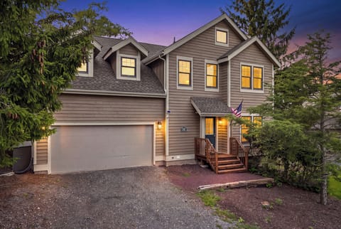 Twilight exterior of the home with warm lighting and welcoming curb appeal.
