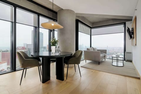 Bright living and dining area with stunning city views.