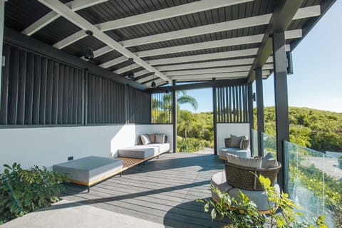 Sip cocktails in shaded comfort with panoramic hillside views.