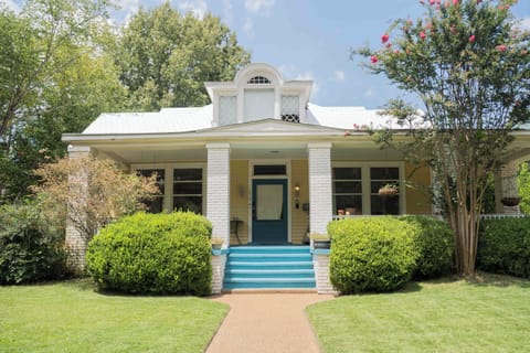 Charming front porch with lush landscaping and standout curb appeal
