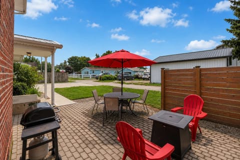 Patio area featuring comfortable outdoor seating, a propane grill, and a propane fire pit.