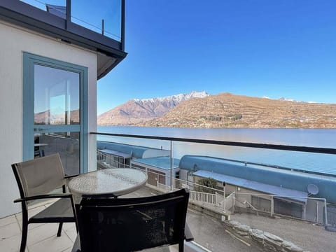 Private balcony with uninterrupted views across Lake Wakatipu and the surrounding alpine peaks.