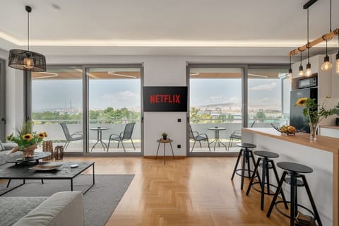 Open-plan living and kitchen with balcony access