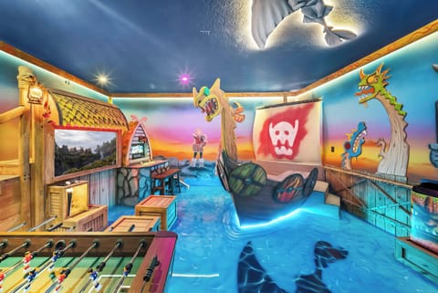 Step into a vibrant playroom adorned with colorful murals and a whimsical pirate ship, where fun and creativity flourish. With its unique decor and interactive features, this space promises an unforgettable experience for all.