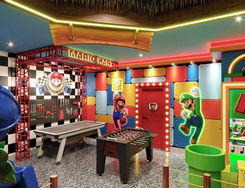 Step into a vibrant game room designed for endless fun, featuring colorful decor, playful Mario-themed walls, and an exciting foosball table. The lively atmosphere is perfect for families looking to unwind and enjoy together.