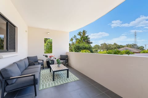 Settle into the patio with comfortable outdoor seating, where leafy surrounds and the covered setting create an inviting spot for your morning coffee or an evening drink in the tropical air.