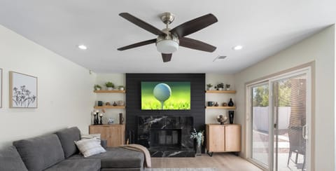 Bright modern living room with fireplace, large sectional, and patio access