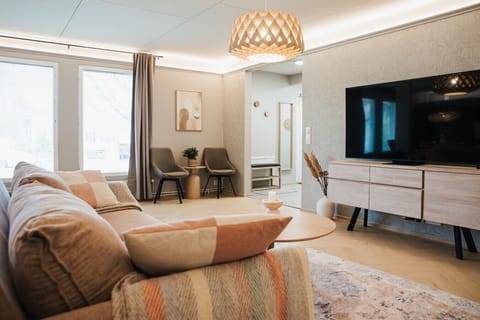 A warm, welcoming lounge with a plush sofa and stylish decor to unwind after a day out.