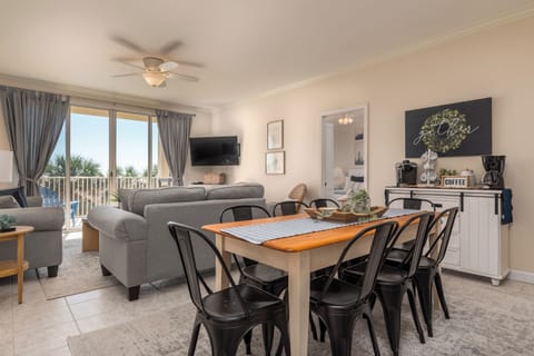 Your open-concept living space flows seamlessly from cozy seating to dining table, with coffee bar ready for morning rituals and balcony views.