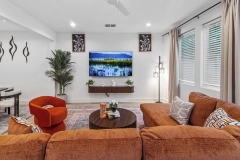 Bright modern living room with plush seating and large smart TV