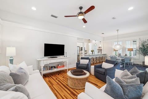 Unwind in your spacious living area where modern comfort meets coastal elegance, complete with plush seating and open-concept design.
